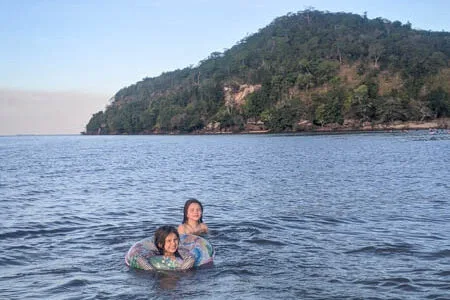 children diving in the river at sunset in Ponta do Cururu