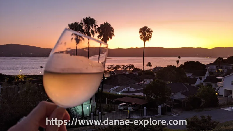 Glass of wine at sunset, on the edge of Knysna Lagoon, Garden Route, South Africa