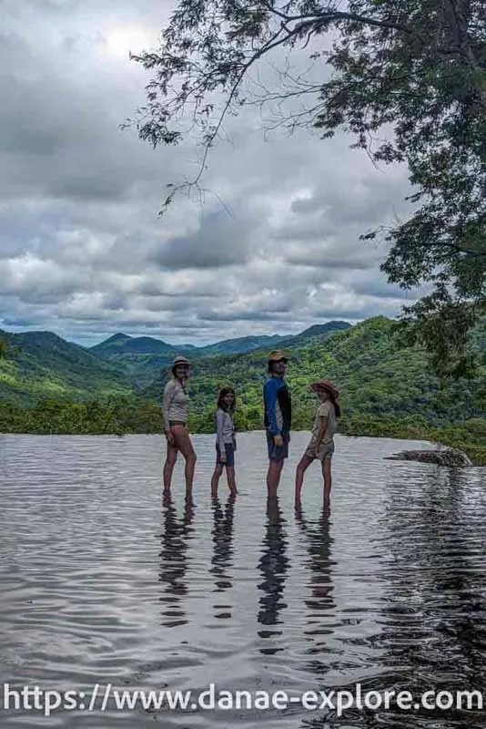  Family (2 adults and 2 children) in a waterfall well, with views of a valley in the background, Boca da Onça - everything you need to know to visit Bonito
