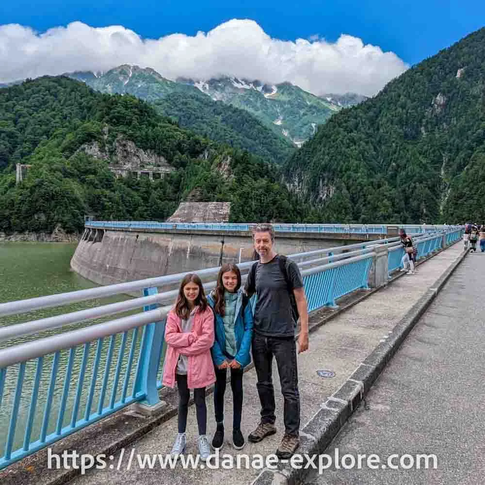 Father and two daughters, at Kurube Dam, Japan - what it's like to cross the Japanese Alps - www.danae-explore.com