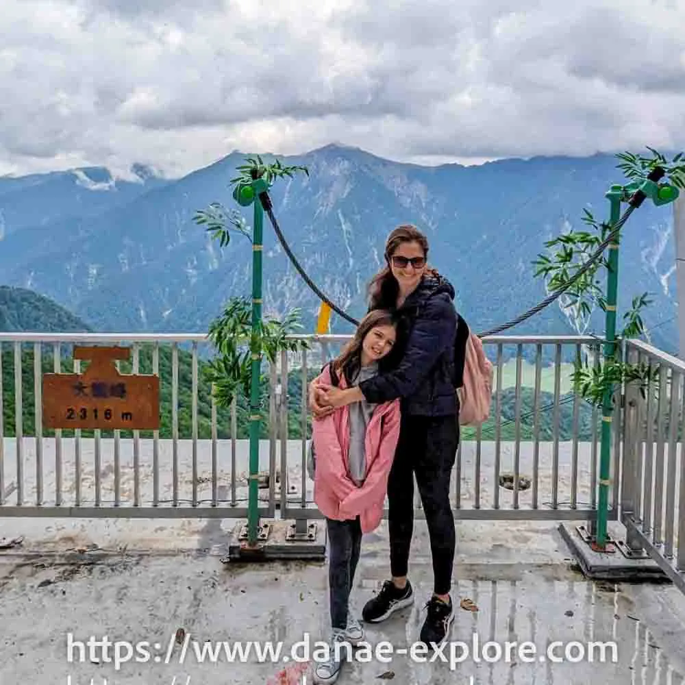 Mother and daughter hug at the viewpoint in Daikanbo - Tateyama Kurobe Alpine Route, as it is the crossing of the Japanese Alps