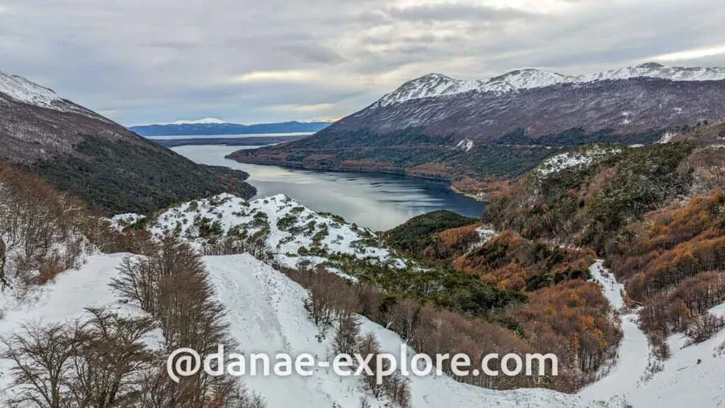 View of the Escondido and Fagnano sides from Paso Garibaldi. There is autumn vegetation and snow on the mountain peaks.