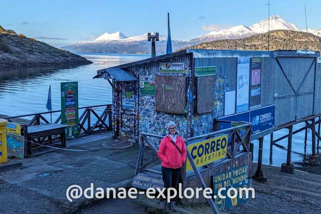 Girl in red coat and hat, in Zaratiegui Cove, in front of the post office at the end of the world, in Tierra del Fuego National Park