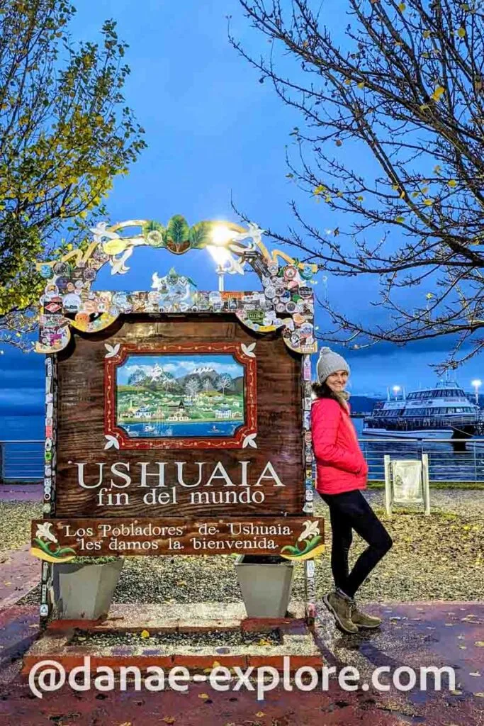 Me at the classic sign, on the pier of Ushuaia, where it reads "Ushuaia Fin del Mundo - Los Plobadoes de Ushuaia les damos la bienvenida" - it's a clear night