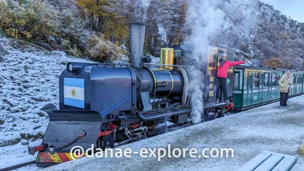 Girl in red coat at the door of the locomotive of the End of the World Train, Tierra del Fuego National Park