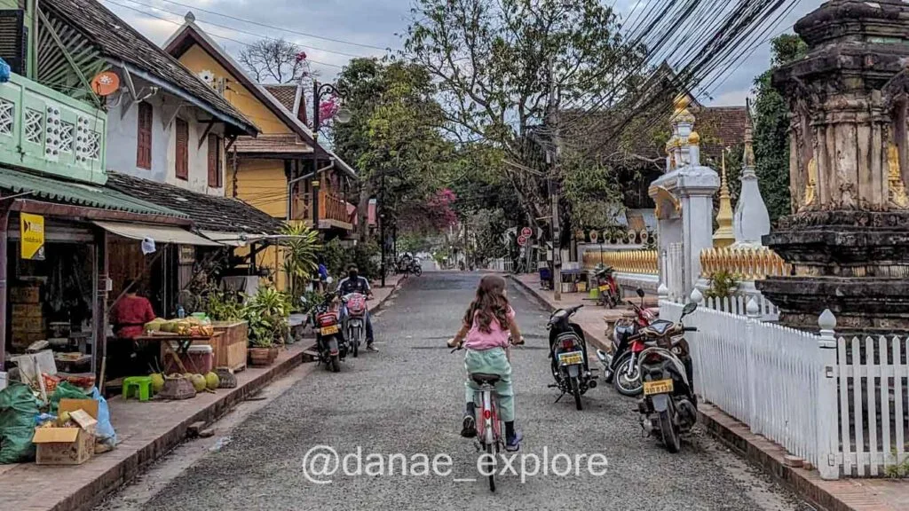 girl riding a bicycle in Luang Prabang, Laos.