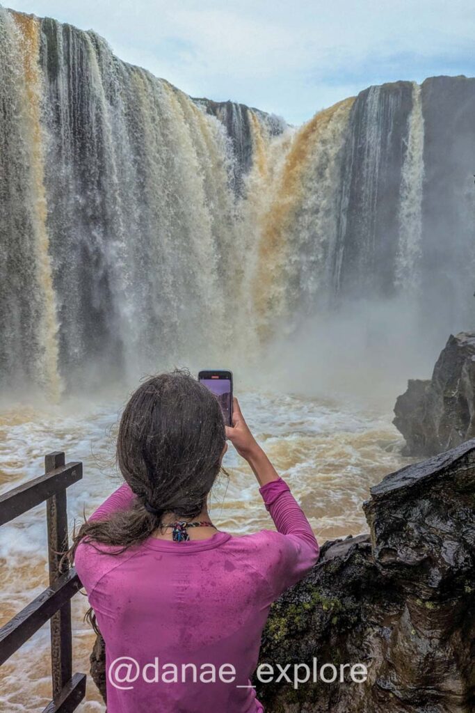 Moça de costas para câmera tirando foto da Cachoeira da Prata, no Parque Nacional da Chapada das Mesas, Maranhão