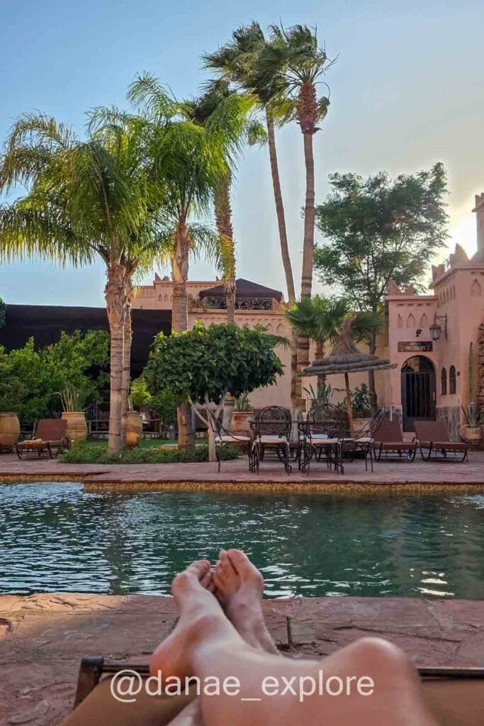 Me relaxing by the pool at Hotel Ksar Ighnda in Ouarzazate, my favorite stay from our ten-day trip to Morocco