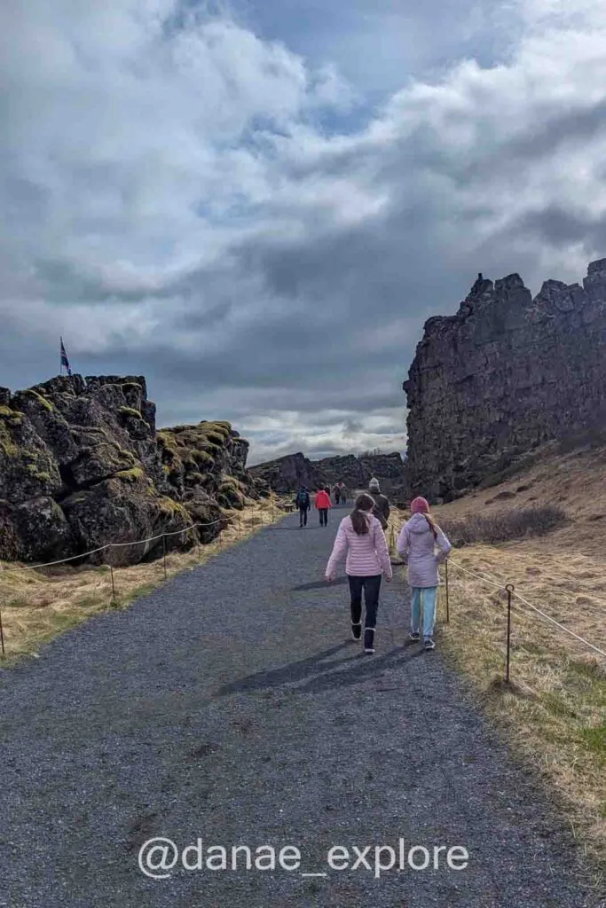 People walking along the trail between the tectonic plates in Þingvellir National Park, another tour I highly recommend doing in Iceland.
