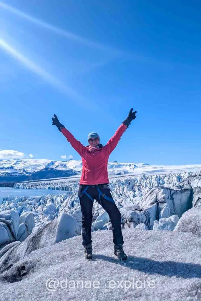 Here I am at the end of the trail on the ice at the Vatnajökull glacier, surrounded by ice and mountains. You can see a bit of Jokulsárlón in the background to the left. It's a sunny day with a blue sky.