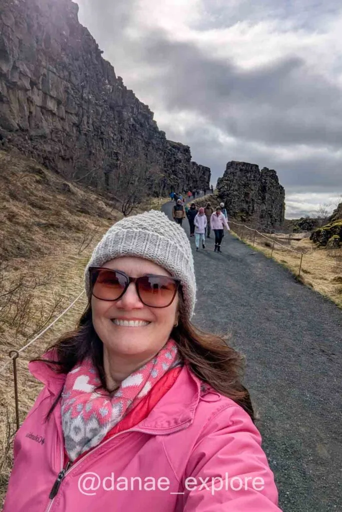 Selfie on the trail between the rock walls in Þingvellir National Park, on a cloudy day.